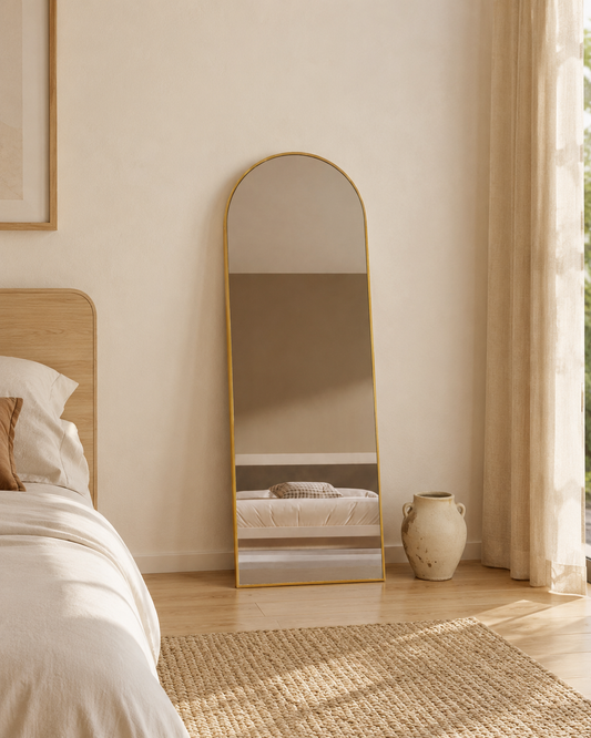 Sienna arch mirror 1700 x 610 in Antique Copper, styled leaning in a bedroom corner