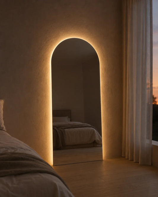 Sienna LED arch mirror glowing at dusk in a bedroom