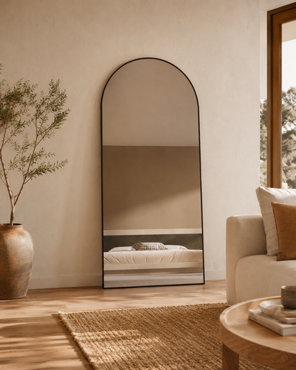 Sienna oversized arch mirror 2000 x 1100 in Matte Black, styled leaning in a living room